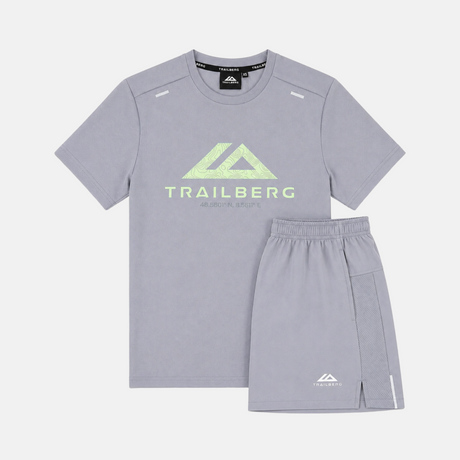 A kids' two-piece athletic set featuring a light gray short-sleeve t-shirt and matching shorts. The t-shirt has a light green Trailberg logo on the chest, and the shorts have a small white logo near the hem.