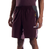 A model from the waist down wearing dark maroon athletic shorts with a gray side panel, black crew socks, and black running shoes, shown against a plain white background.