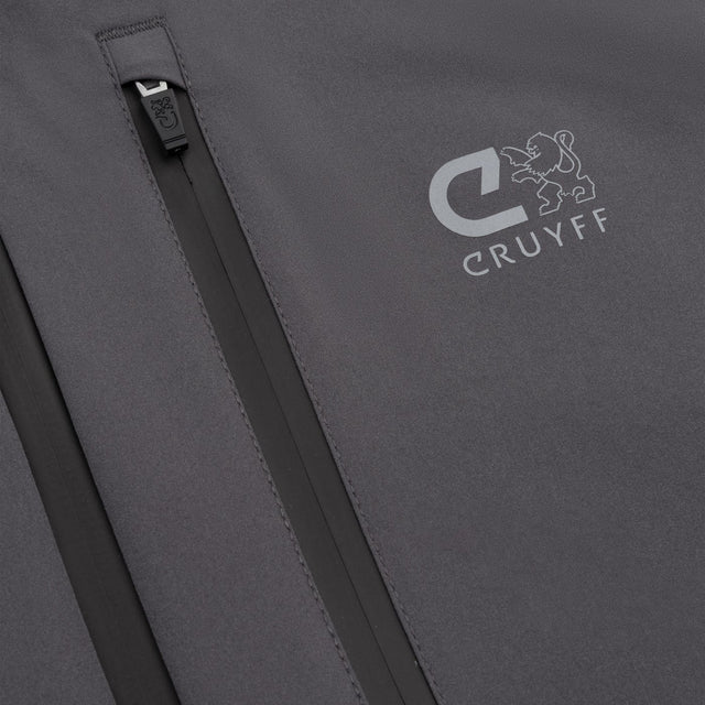 Close-up of a dark gray jacket or backpack with a vertical zip pocket and a white CRUYFF logo printed on the side.
