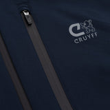 Close-up of a dark navy softshell jacket with a vertical zippered pocket and a light gray embroidered CRUYFF logo on the chest.