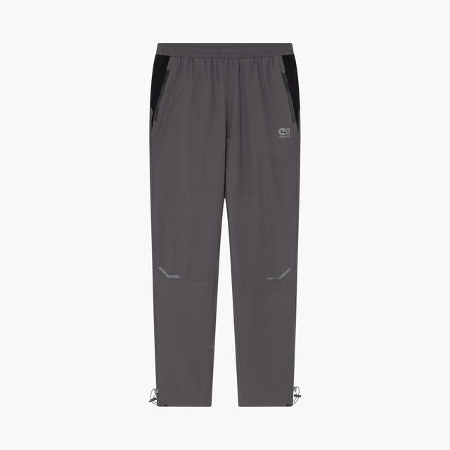 A pair of dark gray athletic pants with black side panels, a small white logo on the left thigh, and adjustable drawstring hems, shown against a plain white background.