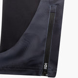 Close-up of dark blue pants with a zipper detail on a white background