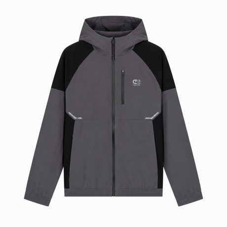 A colorblock hooded jacket in dark gray and black, featuring a full-zip front, a small white logo on the left chest, and reflective silver details on the front pockets, shown against a plain white background.