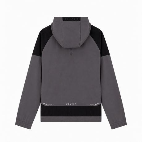 A gray and black color-blocked hooded jacket shown from the back, featuring a small white 'Cruyff' logo near the bottom hem, displayed on a clean white background.