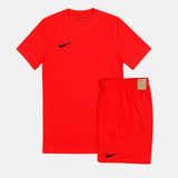 Red Nike athletic shirt and shorts set on a white background